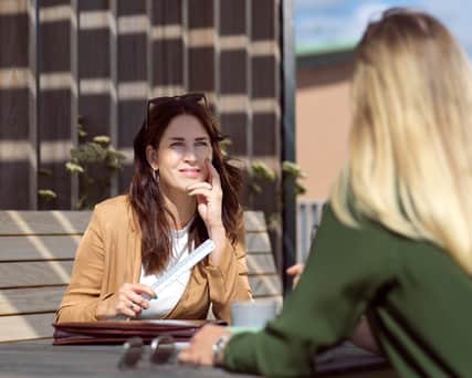 Två personer som sitter mittemot varandra med varsin dator.